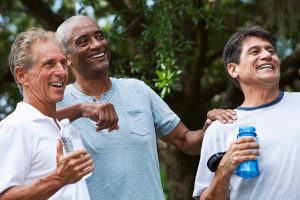Men with sleep apnea laughing together because they are well-rested and healthy