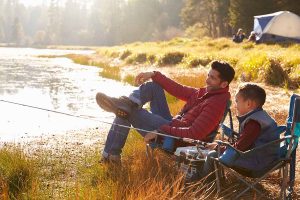 man fishing with son after getting treatment for low testosterone for better mood, energy, and health