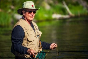 Man fishing and smiling because he started testosterone replacement therapy for low testoserone levels