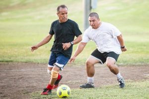 Men playing soccer after improving muscle mass with testosterone treatment