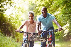 woman and man biking after man's testosterone replacement