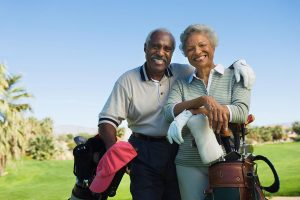 older couple playing golf after treating low testosterone