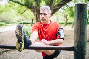 man stretching while running after testosterone replacement