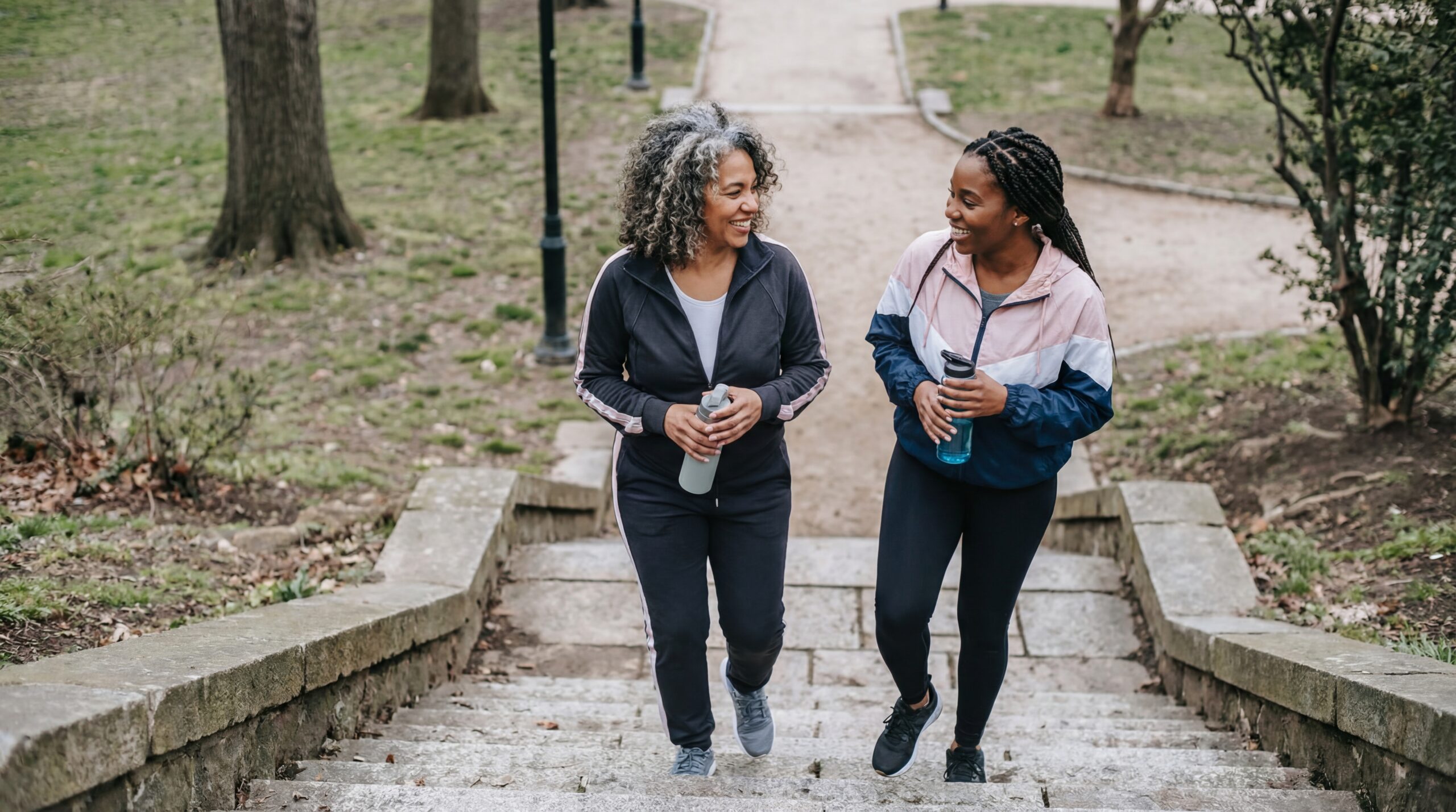 Two women walking together outdoors, staying active during Bi-Est estrogen cream therapy